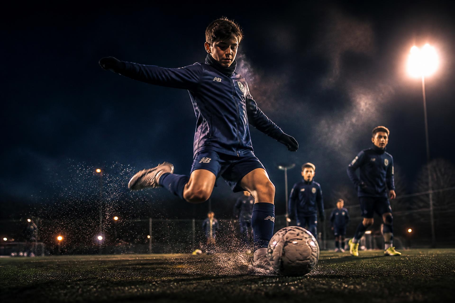 Academy players training under floodlights